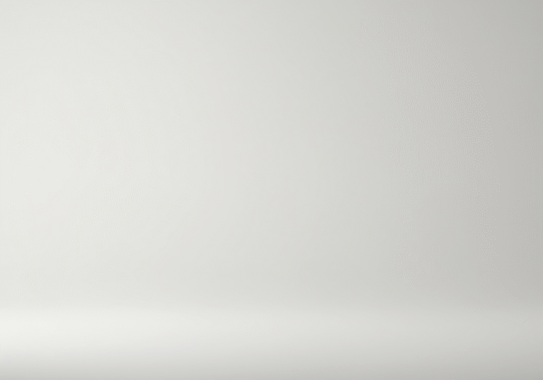 A crisp, perfectly smooth, stark white surface, devoid of any marks or objects, bathed in uniform, soft studio lighting, creating subtle, defined shadows that emphasize its absolute blankness, photorealistic editorial photography, high resolution.