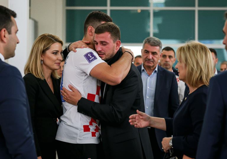 A visibly emotional Croatian captain Marko Bekavac, appearing weary yet overcome with relief, is embraced by his brother Jozo Bekavac and other family members on the morning of August 9, 2025, in a public area in Croatia, possibly an airport arrivals lounge or government building entrance. His attorney, Jasna Kotarac Jabuka, stands close by, observing the poignant reunion with a look of quiet satisfaction. The scene is bathed in soft, natural morning light, capturing the profound moment of his unexpected return after 22 months in a Turkish prison.